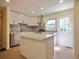 Updated kitchen features white cabinets, stainless appliances, and center island at 2422 Clarissa Nw Dr, Atlanta, GA 30318