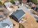 Aerial view of the back of the home showing a deck and wooded surroundings in a suburban neighborhood at 4790 Maristone Landing Way, Cumming, GA 30040