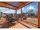 Relaxing back deck with a shaded pergola and an outdoor dining set at 4790 Maristone Landing Way, Cumming, GA 30040