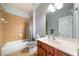 Well-lit bathroom with tiled shower-tub combo and modern vanity at 4790 Maristone Landing Way, Cumming, GA 30040