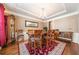 Formal dining room with a wooden table, six chairs, and dark hardwood flooring at 4790 Maristone Landing Way, Cumming, GA 30040