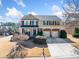 Two-story home with brick and tan siding, well-manicured lawn, and a two-car garage at 4790 Maristone Landing Way, Cumming, GA 30040