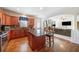 Spacious kitchen with wood cabinets, granite countertops, stainless steel appliances, and hardwood floors at 4790 Maristone Landing Way, Cumming, GA 30040