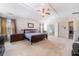Main bedroom features tray ceiling, sitting area, and en-suite bathroom at 4790 Maristone Landing Way, Cumming, GA 30040