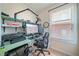 Cozy home office with desk, shelves, microphone, and window that allows plenty of natural light to brighten the room at 4790 Maristone Landing Way, Cumming, GA 30040