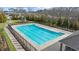 Community pool with swimming lanes and a playground in a fenced area, perfect for Gathering recreation at 7330 Olivia View Ct, Cumming, GA 30028