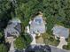 Aerial view showcases property with pool, deck, and mature trees for privacy in a quiet neighborhood at 1012 Jubilee Way, Powder Springs, GA 30127