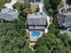 Aerial view showcasing the house, pool, and outdoor living space amidst a lush, private setting at 1012 Jubilee Way, Powder Springs, GA 30127