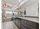 Contemporary bathroom featuring a tiled floor, dual vanity with granite countertop, and a soaking tub at 1012 Jubilee Way, Powder Springs, GA 30127