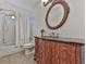 Bathroom with a classic vanity and an oval mirror complements the tub-shower with a white curtain at 1012 Jubilee Way, Powder Springs, GA 30127