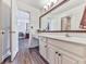 Bathroom with a white vanity, mirror, and wood-look flooring at 1012 Jubilee Way, Powder Springs, GA 30127