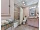 Cozy bathroom with a shower-tub combo, neutral tile, and classic fixtures at 1012 Jubilee Way, Powder Springs, GA 30127