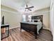 Bedroom featuring a dark wood bed frame with a fan and dark wood vinyl plank flooring at 1012 Jubilee Way, Powder Springs, GA 30127