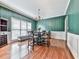 Dining room featuring an elegant chandelier, wood floors, and large windows at 1012 Jubilee Way, Powder Springs, GA 30127