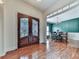 Foyer with decorative glass front door, wood floors, and a view of the dining area at 1012 Jubilee Way, Powder Springs, GA 30127