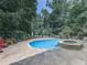 Spacious backyard with a pool, spa, and a lounge area at 1012 Jubilee Way, Powder Springs, GA 30127