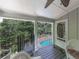 Inviting covered porch with black railings overlooking the pool and backyard oasis at 1012 Jubilee Way, Powder Springs, GA 30127