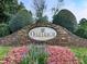 Stone entrance sign to the Oakleigh community, framed by colorful flowers and manicured landscaping at 1012 Jubilee Way, Powder Springs, GA 30127