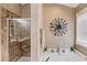 Bright bathroom featuring a soaking tub next to a glass enclosed shower with tiled walls at 1042 Wildwood Wake Bnd, Dacula, GA 30019