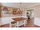 Dining room with a table, chairs, decorative shelving, and a view into the adjacent kitchen at 1042 Wildwood Wake Bnd, Dacula, GA 30019