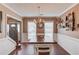 Dining room with wood flooring, a staircase, a decorative light fixture, and shelving at 1042 Wildwood Wake Bnd, Dacula, GA 30019