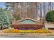 Evergreen community entrance sign surrounded by colorful flower beds at 1042 Wildwood Wake Bnd, Dacula, GA 30019