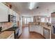 Kitchen with stainless steel appliances, stone countertops, and a view into an eat-in area at 1042 Wildwood Wake Bnd, Dacula, GA 30019