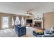 Bright living room featuring a brick fireplace, a ceiling fan, and a comfortable seating arrangement at 1042 Wildwood Wake Bnd, Dacula, GA 30019