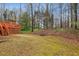 Backyard view with a deck, stairs, a wooded area, and a spacious lawn at 2795 Kakki Ct, Marietta, GA 30062