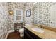 Powder room with granite counters, dark wood floors, and charming wallpaper at 2795 Kakki Ct, Marietta, GA 30062