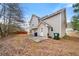 Spacious backyard featuring a patio area, wooden fence, and lush foliage surrounding the property at 3999 Craggy Perch, Douglasville, GA 30135