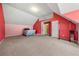 Bonus room with carpet flooring, white ceiling, pink and salmon accent walls, and closet door for storage at 3999 Craggy Perch, Douglasville, GA 30135