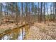 Scenic creek running through the wooded backyard of the property, offering a tranquil natural setting at 3999 Craggy Perch, Douglasville, GA 30135