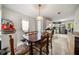 Open dining area with a dark wood table and an adjacent kitchen with stainless steel appliances at 3999 Craggy Perch, Douglasville, GA 30135