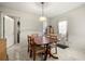 Cozy dining area with a wooden table and chairs, next to a bright window and door at 3999 Craggy Perch, Douglasville, GA 30135