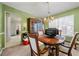 Bright dining room featuring a wooden table with an antique hutch, illuminated by a chandelier at 3999 Craggy Perch, Douglasville, GA 30135