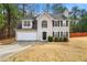 Charming two-story home featuring a two-car garage, classic black shutters, and a well-manicured lawn at 3999 Craggy Perch, Douglasville, GA 30135