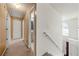 Hallway with multiple doors leading to different rooms, and a window showing a view of the backyard at 3999 Craggy Perch, Douglasville, GA 30135