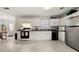 Well-lit kitchen with white cabinets, black appliances, and a window to the outside at 3999 Craggy Perch, Douglasville, GA 30135