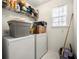 Functional laundry room with a washer, dryer, storage shelves and natural light from the window at 3999 Craggy Perch, Douglasville, GA 30135