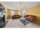 Bright and airy living room with plush sofas, a fireplace, and large windows providing natural light at 3999 Craggy Perch, Douglasville, GA 30135