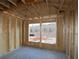 This bedroom is in the framing stage, showing studs, plywood, and future window views at 436 Maypop Lane, Woodstock, GA 30188