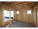 An unfinished room shows exposed framing and construction materials, revealing the structure of the building at 436 Maypop Lane, Woodstock, GA 30188