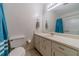 Bathroom featuring vanity, toilet, and tub with blue curtain at 715 Wallington Way, Lawrenceville, GA 30046