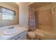 Bright bathroom featuring a shower-tub combo, toilet, and sink with a vanity at 715 Wallington Way, Lawrenceville, GA 30046