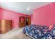 A bedroom featuring carpet, pink walls, closet, and wardrobe at 715 Wallington Way, Lawrenceville, GA 30046