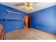 A bedroom featuring shelving, carpet, blue walls, and white ceiling at 715 Wallington Way, Lawrenceville, GA 30046