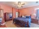 View of a bedroom with a bed, ceiling fan, carpeted floor, and furnishings at 715 Wallington Way, Lawrenceville, GA 30046