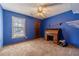 A bedroom featuring a ceiling fan, window, built-in shelving, carpet, and closet at 715 Wallington Way, Lawrenceville, GA 30046