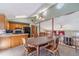 Bright dining area with wooden table and chairs, skylights, and views to the living room and kitchen at 715 Wallington Way, Lawrenceville, GA 30046